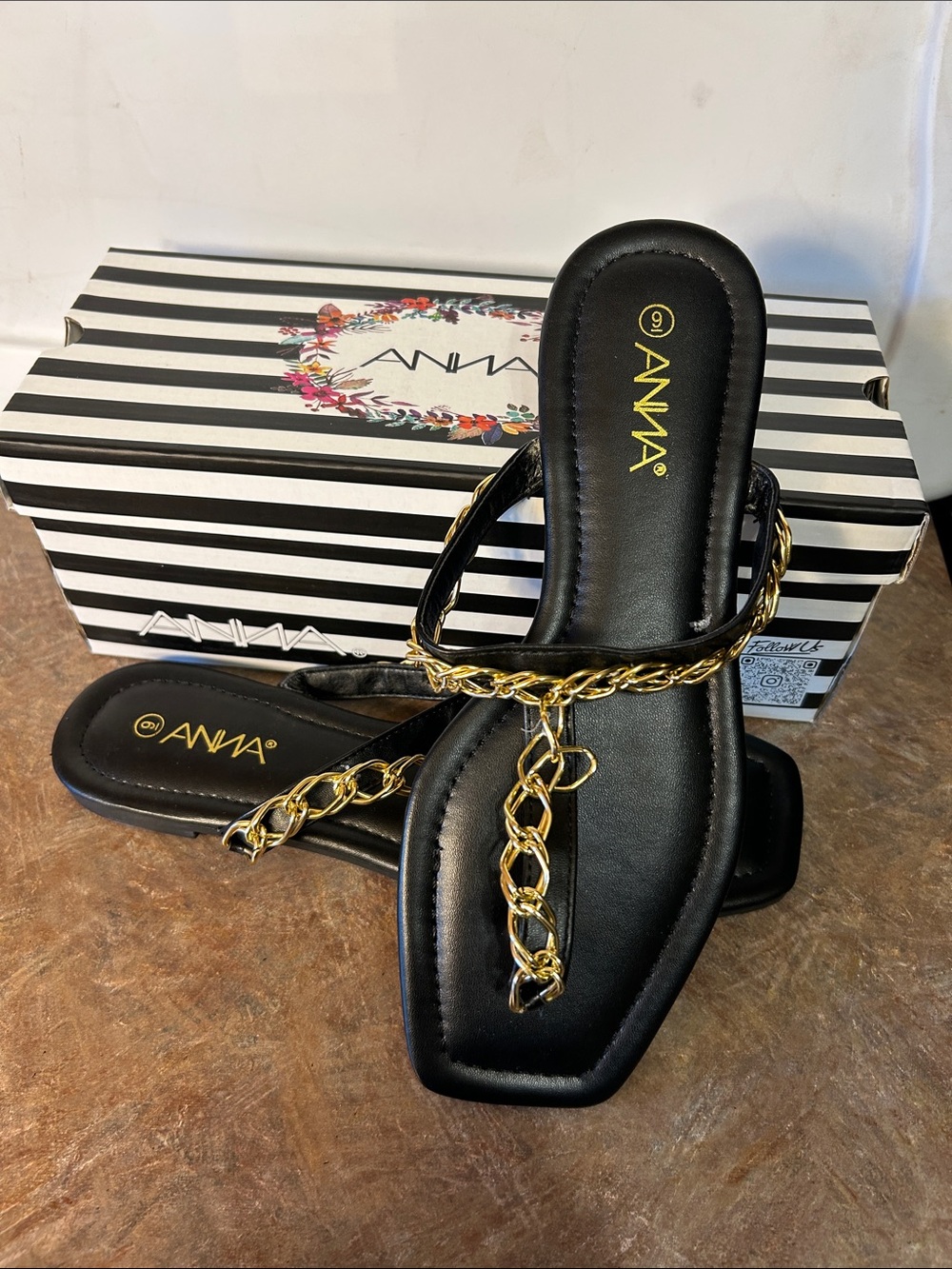 Anna Black Flat Toe Post Sandals with a gold chain and a square toe.